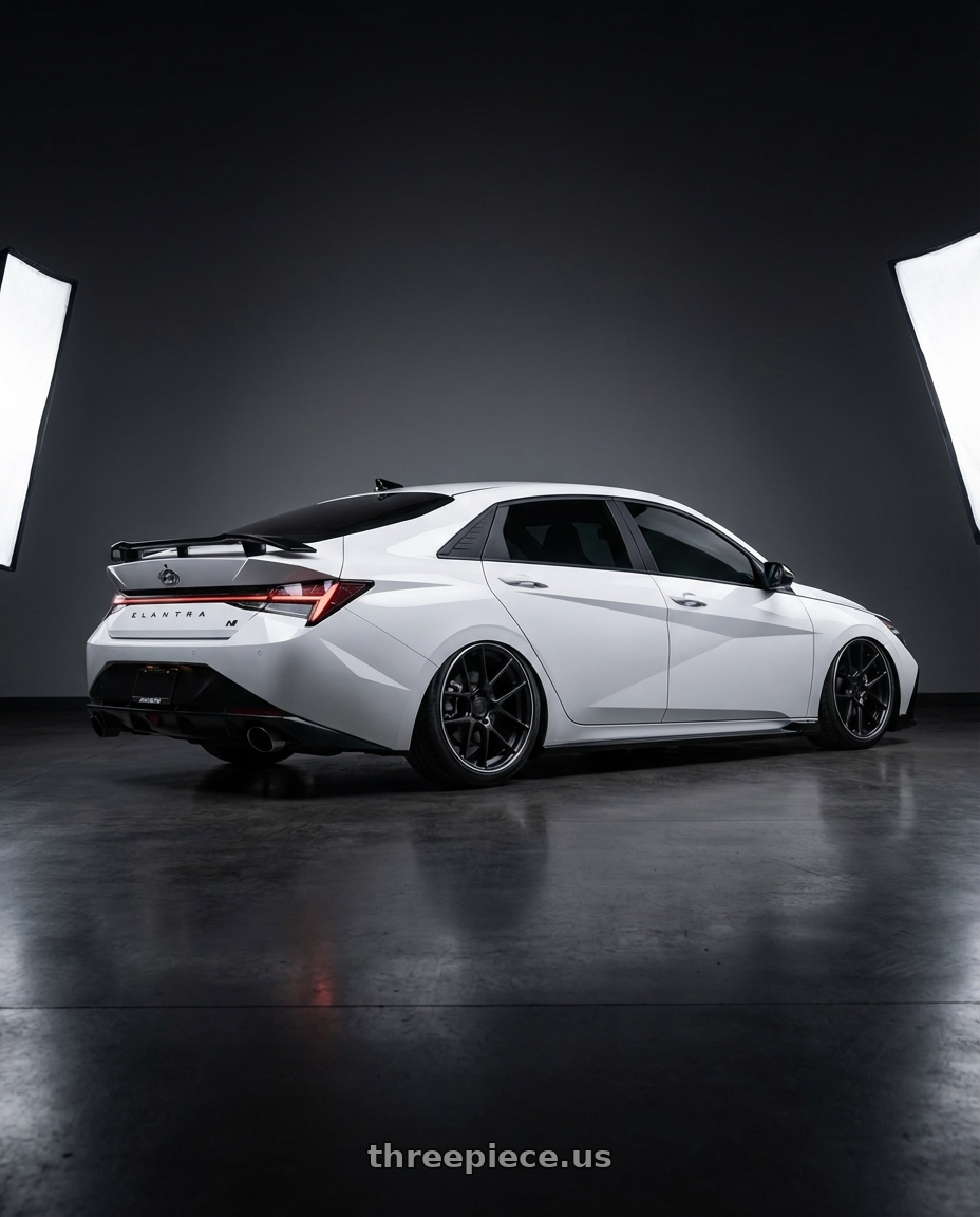 2024 Hyundai Elantra N with Avant Garde Wheels M510 5X114.3 19x9.5 +40 Matte Black wheels rear three quarter view slight stretch tires