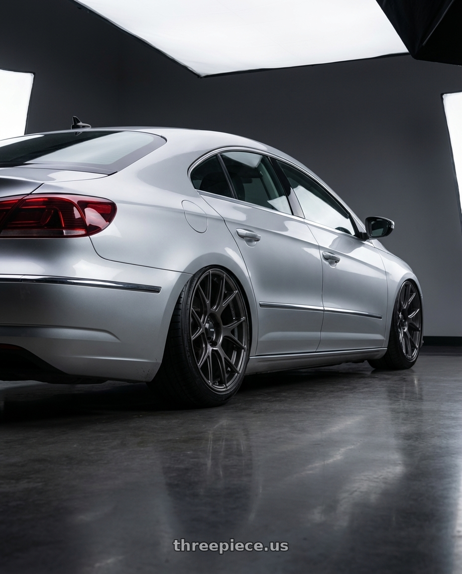 2015 Volkswagen CC with Konig Ampliform 5x112 19x8.5+32 Dark Metallic Graphite wheels rear three quarter view slight stretch tires