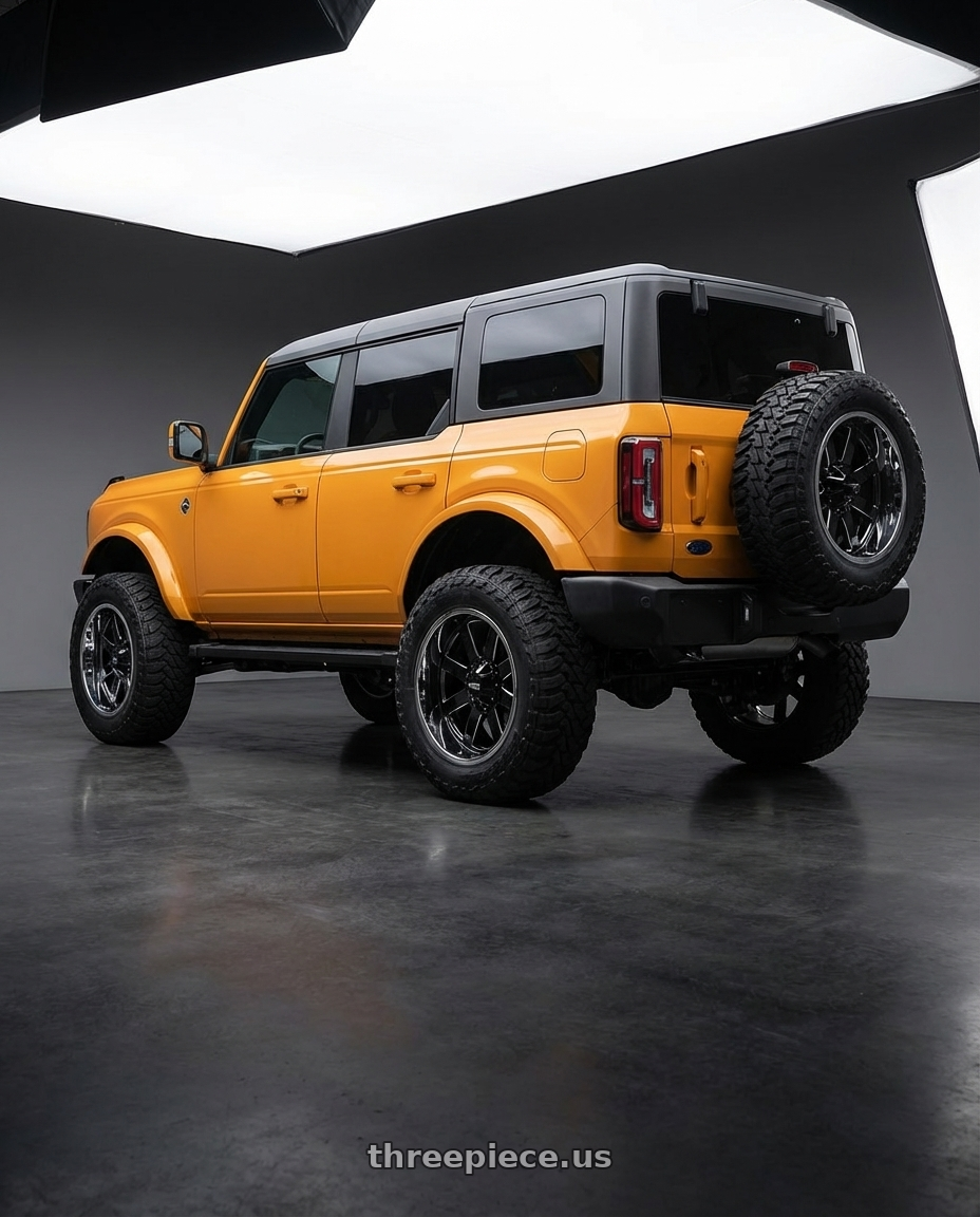 2024 Ford Bronco with Moto Metal MO200 6X139.7 20X10 -18 GLOSS BLACK MILLED CENTER CHROME LIP wheels rear three quarter view meaty tires