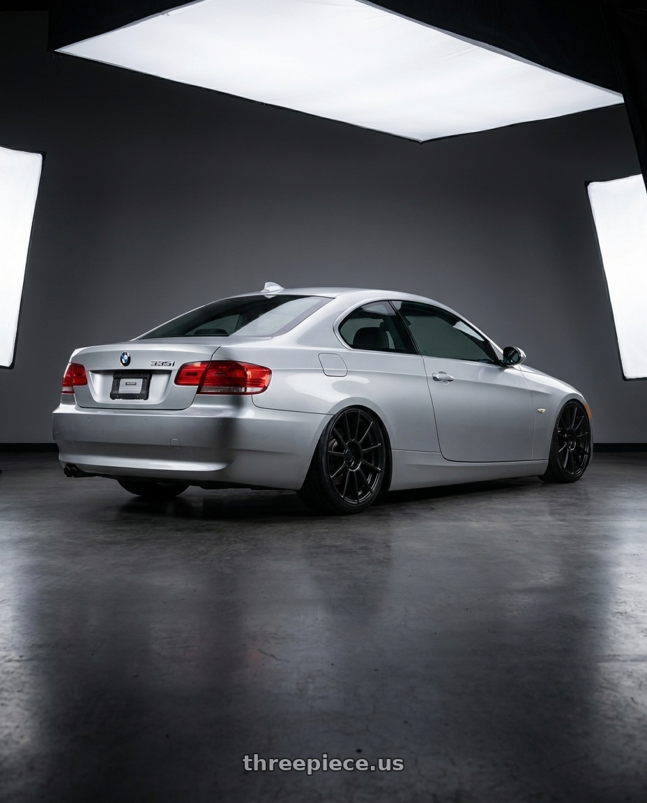 2007 Bmw e92 335i with REPLICA WHEELS R555 4x98 17x7+35 BLACK - SATIN BLACK wheels rear three quarter view slight stretch tires