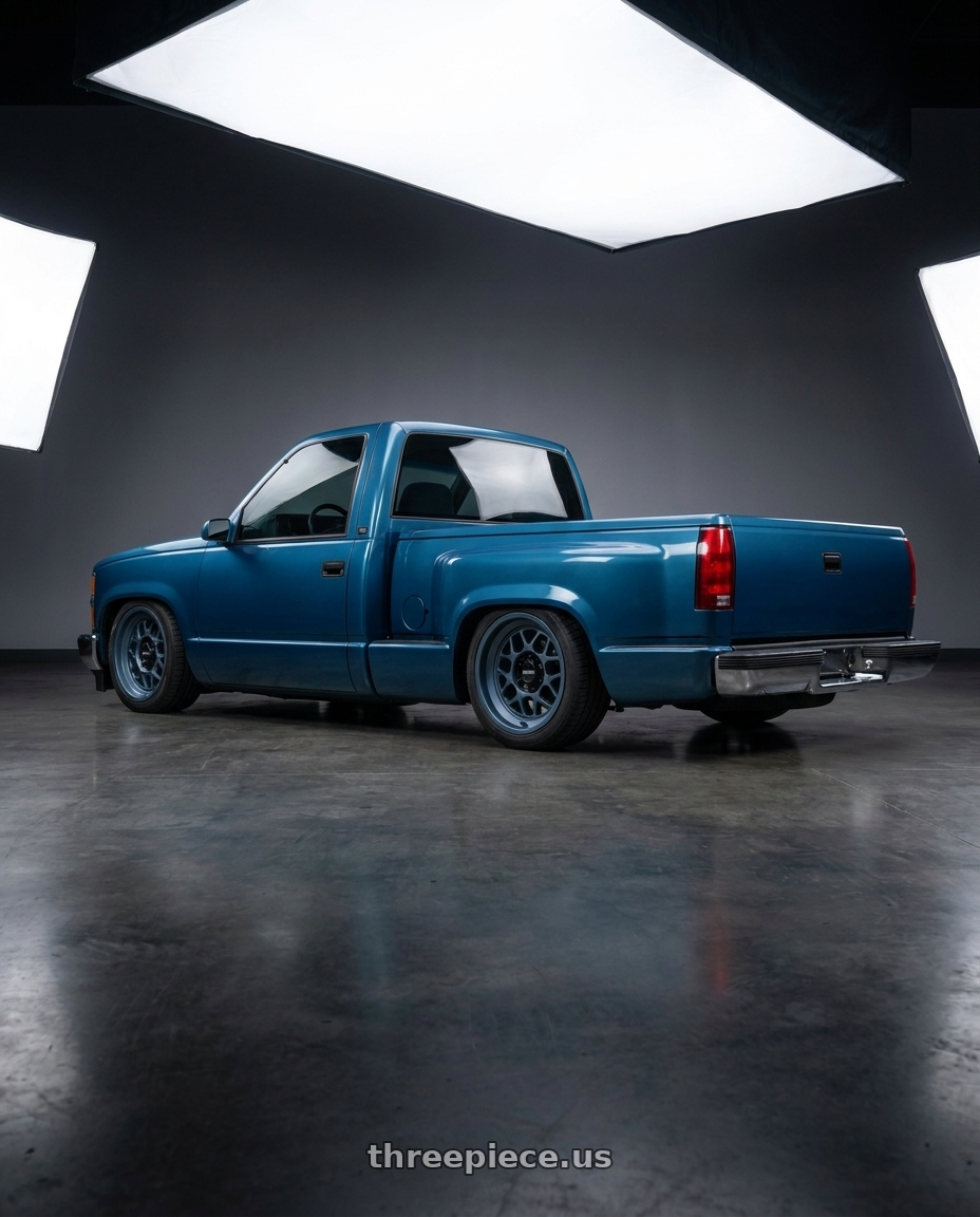 1990 Chevy Silverado blue with KMC KM725 TERRA 5X127 18X8.5 +0 METALLIC BLUE wheels rear three quarter view square tires