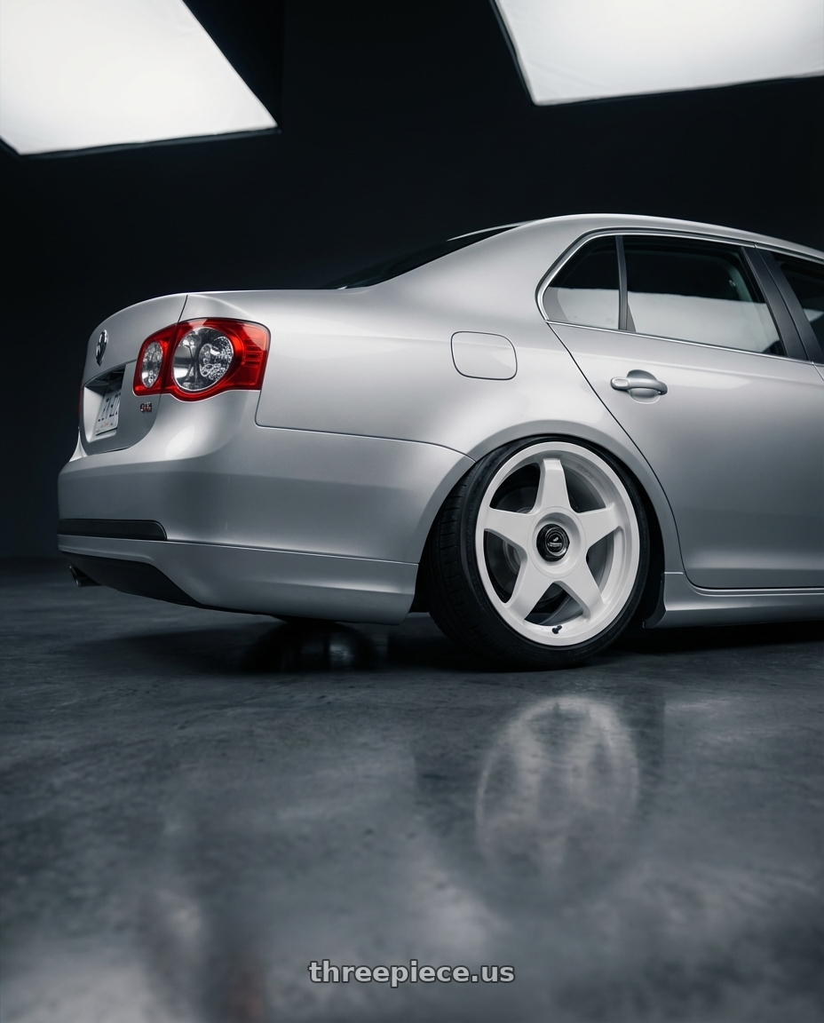 2009 Volkswagen Jetta GLI MK5 with fifteen52 CHICANE 5x112 / 5x120 18x8.5 +35 RALLY WHITE (GLOSS WHITE) wheels rear three quarter view slight stretch tires