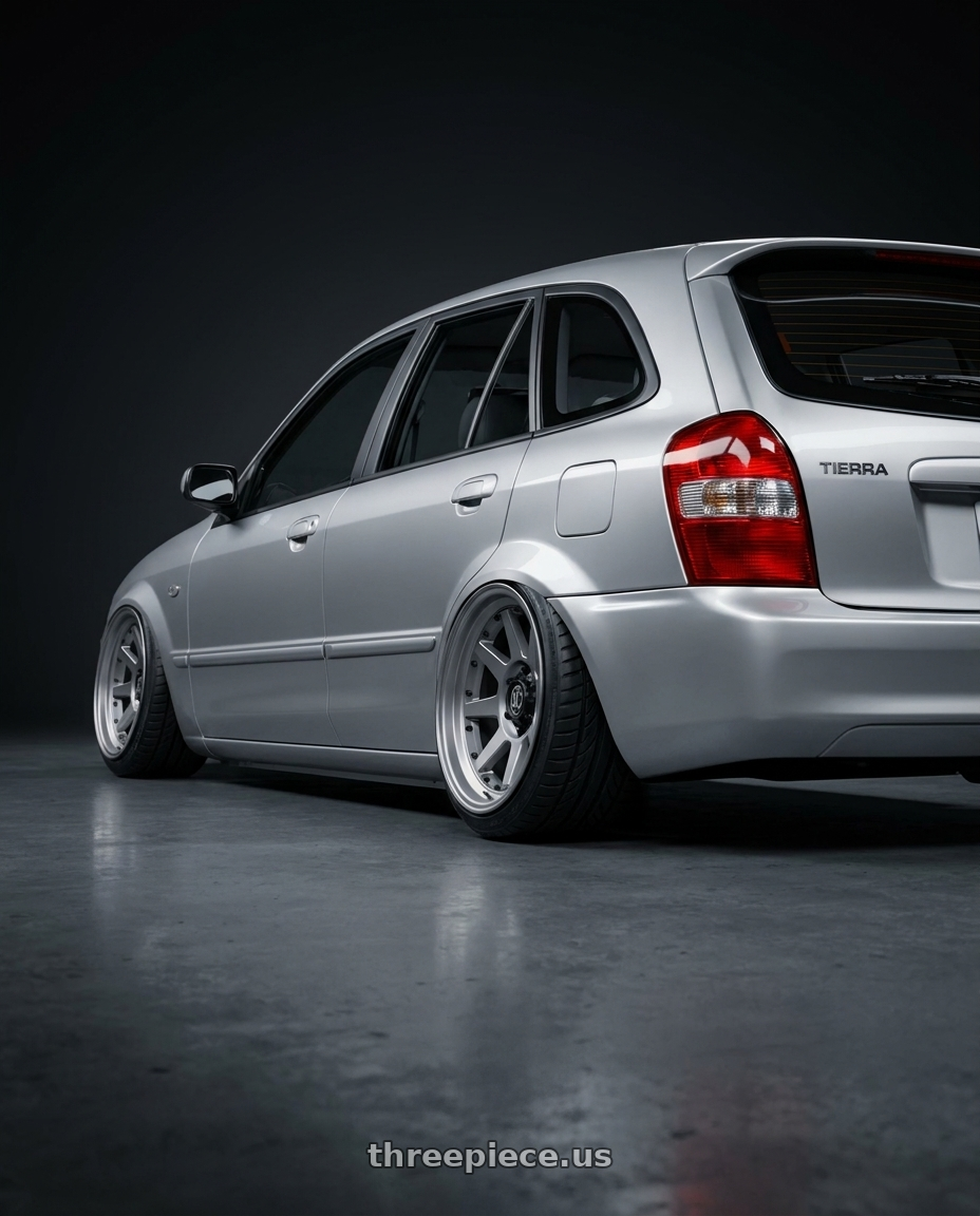 2005 Ford Tierra with Icon Alloys REBOUND PRO 5x127 17x8.5-6 TITANIUM wheels rear three quarter view extreme stretch tires