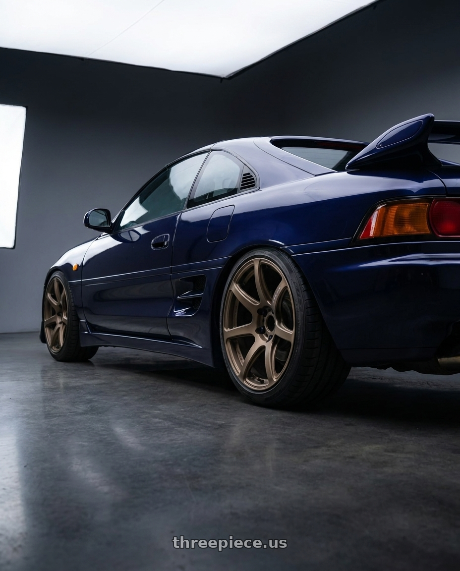 1998 Toyota MR2 with Work Emotion T7r 5x100 18x10.5 +12 Matte Bronze wheels rear three quarter view slight stretch tires