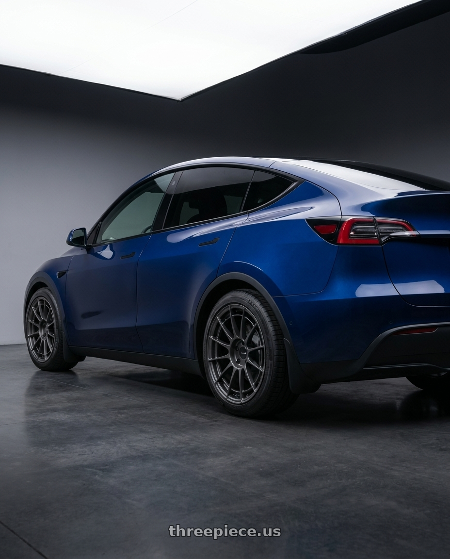 2022 Tesla model y with Enkei NT03RR 5x114.3 17x7.0+48 Matte Gunmetal wheels rear three quarter view square tires