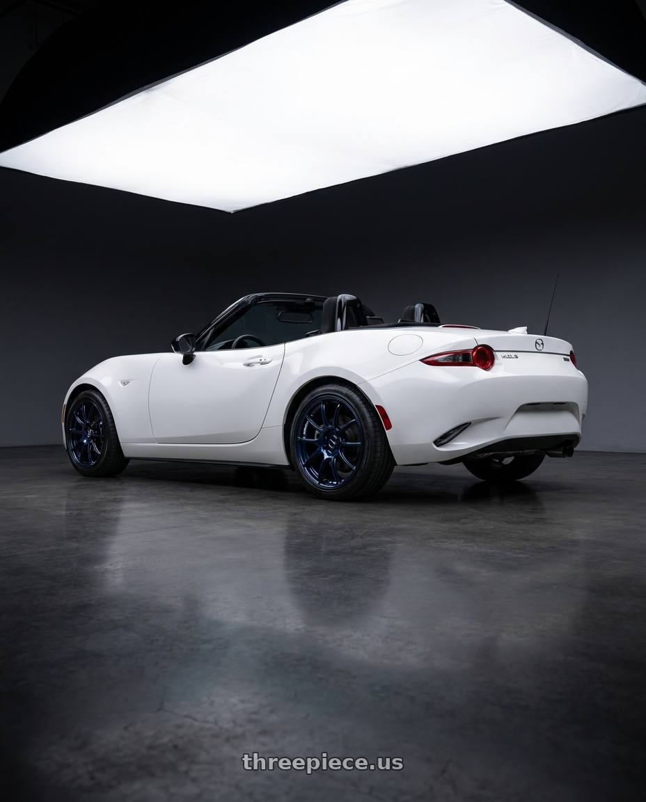2024 Mazda Miata club white  with Advan Racing RZII 4x100 16x7.5 +40 RACING INDIGO BLUE & RING wheels rear three quarter view square tires