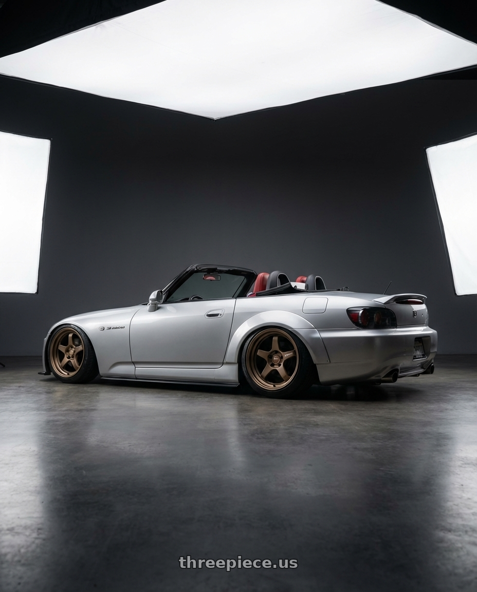 2009 Honda S2000 with Kansei K11B Tandem 5x114.3 18x9.5 22 Bronze wheels rear three quarter view slight stretch tires