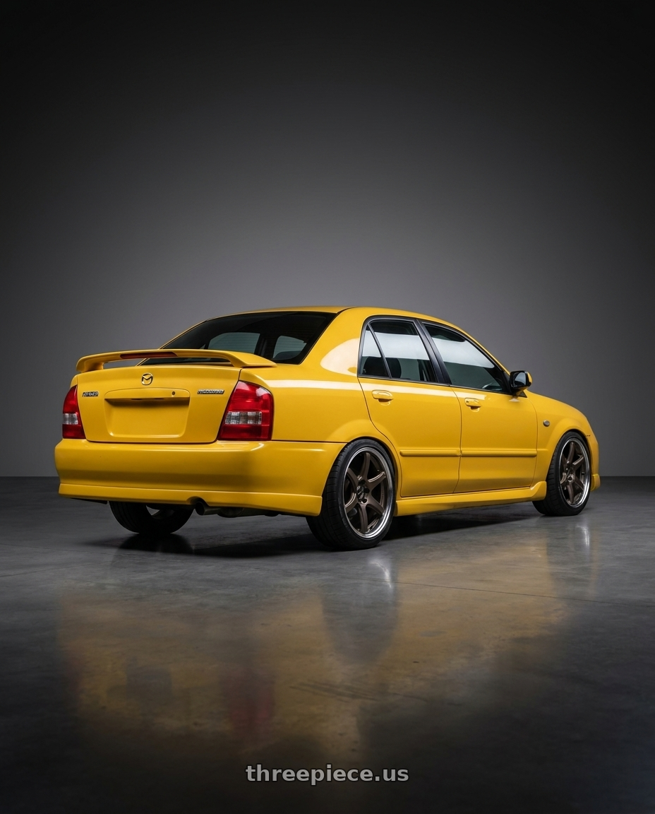 2003 Mazda Protege Mazdaspeed yellow with Work Emotion T7R 2P wheels rear three quarter view square tires