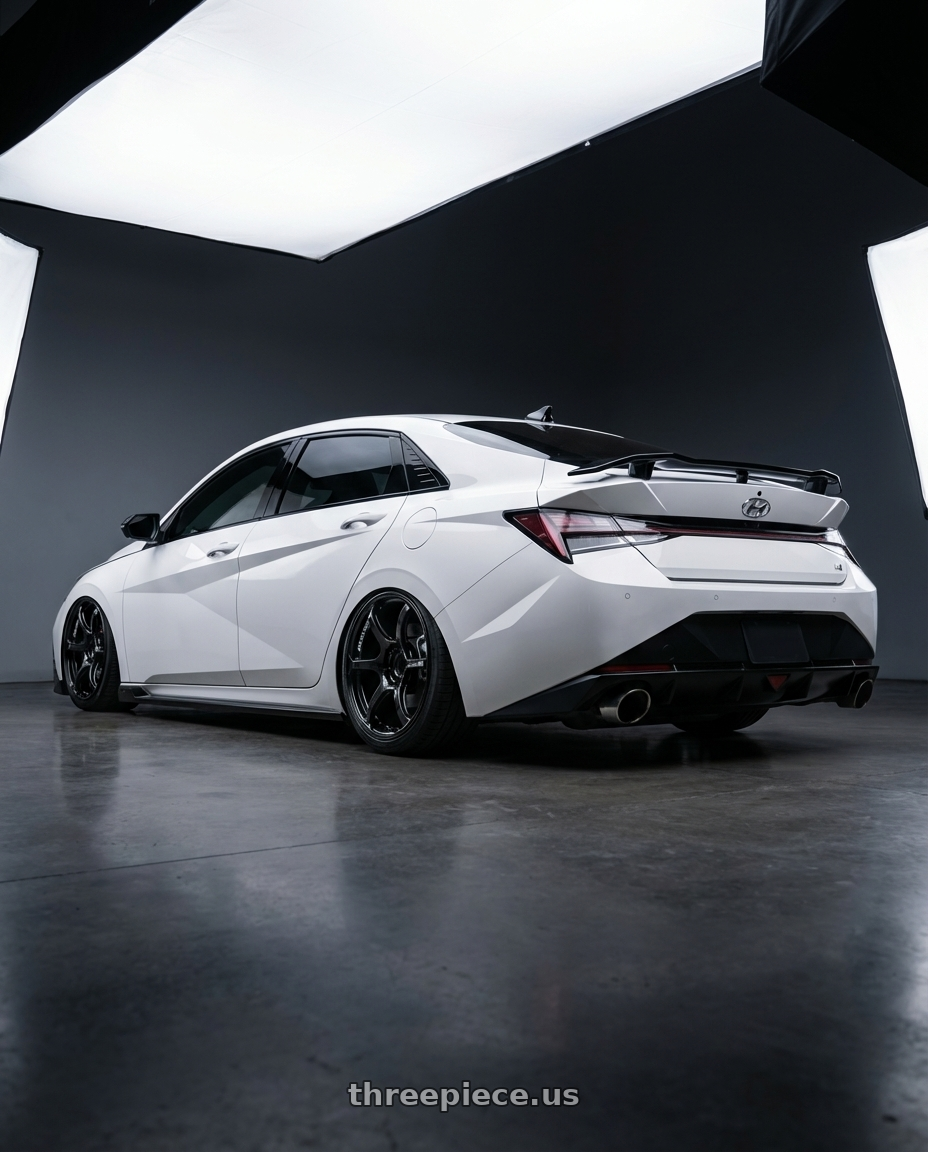 2024 Hyundai Elantra N with Advan RGII 5x114.3 19x10+35 Gloss Black wheels rear three quarter view slight stretch tires