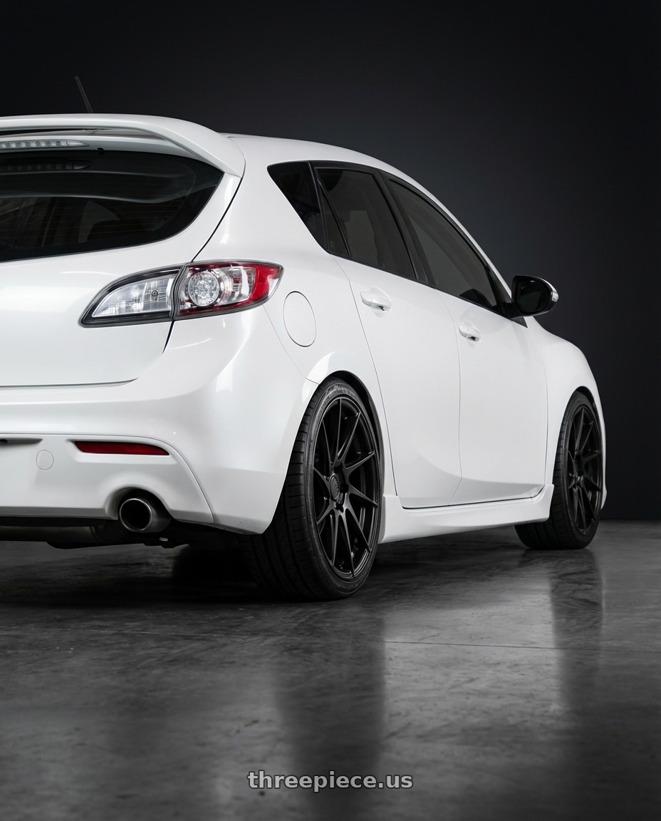 2012 Mazda Mazdaspeed3 with Aodhan AH09 5x114.3 18x8.5 +35 Matte Black wheels rear three quarter view square tires