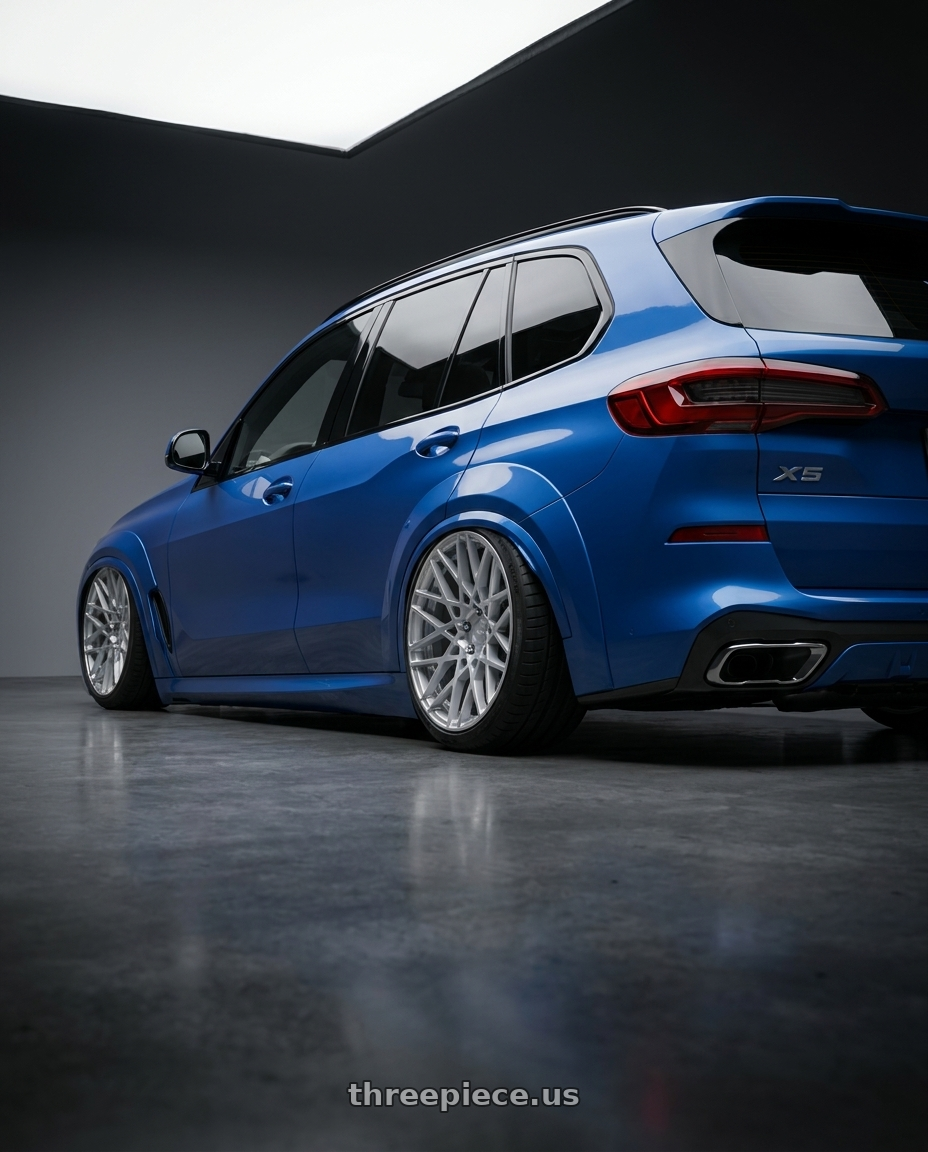 2026 BMW X5 ,blue with Rotiform 1PC R110 BLQ 5X114.3 18X8.5 +38 GLOSS SILVER MACHINED wheels rear three quarter view slight stretch tires