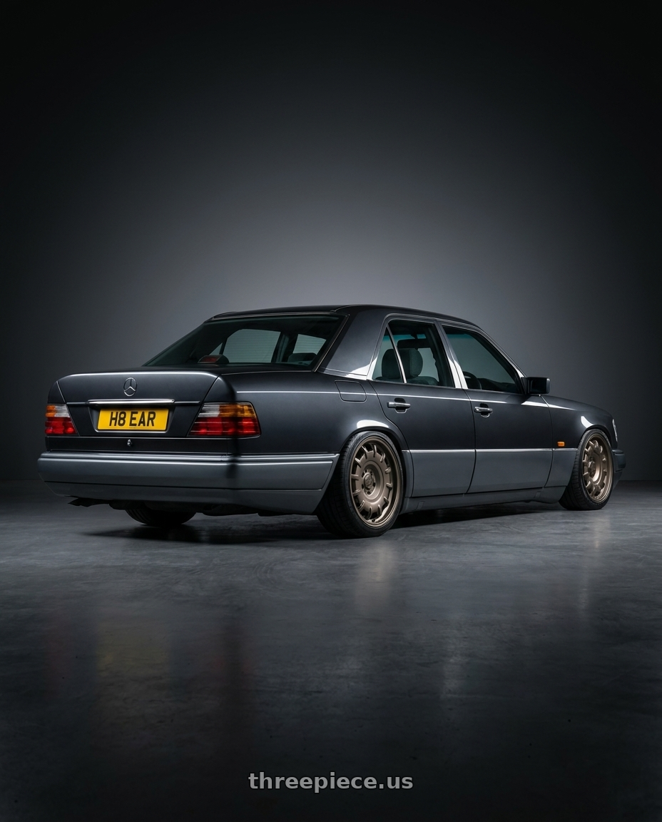 1994 Mercedes Benz E class with fifteen52 BUNDT SV 6x130 17x8 +40 MAGNESIUM GREY (SATIN BRONZE) wheels rear three quarter view square tires