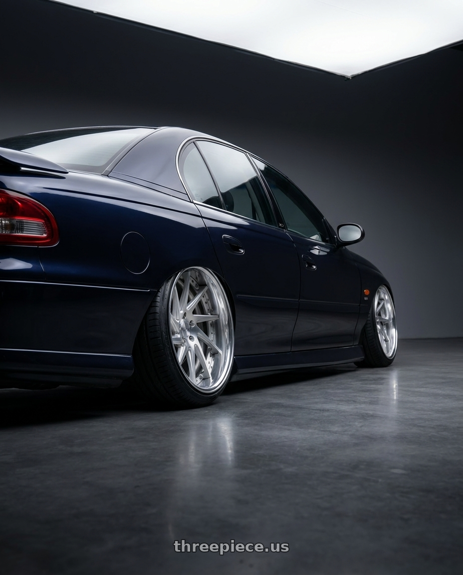 1997 holden vt commodore raven with Work Gnosis Cvs 5x120.65 19x9.5+30 A Disk Brush Silver Clear wheels rear three quarter view extreme stretch tires