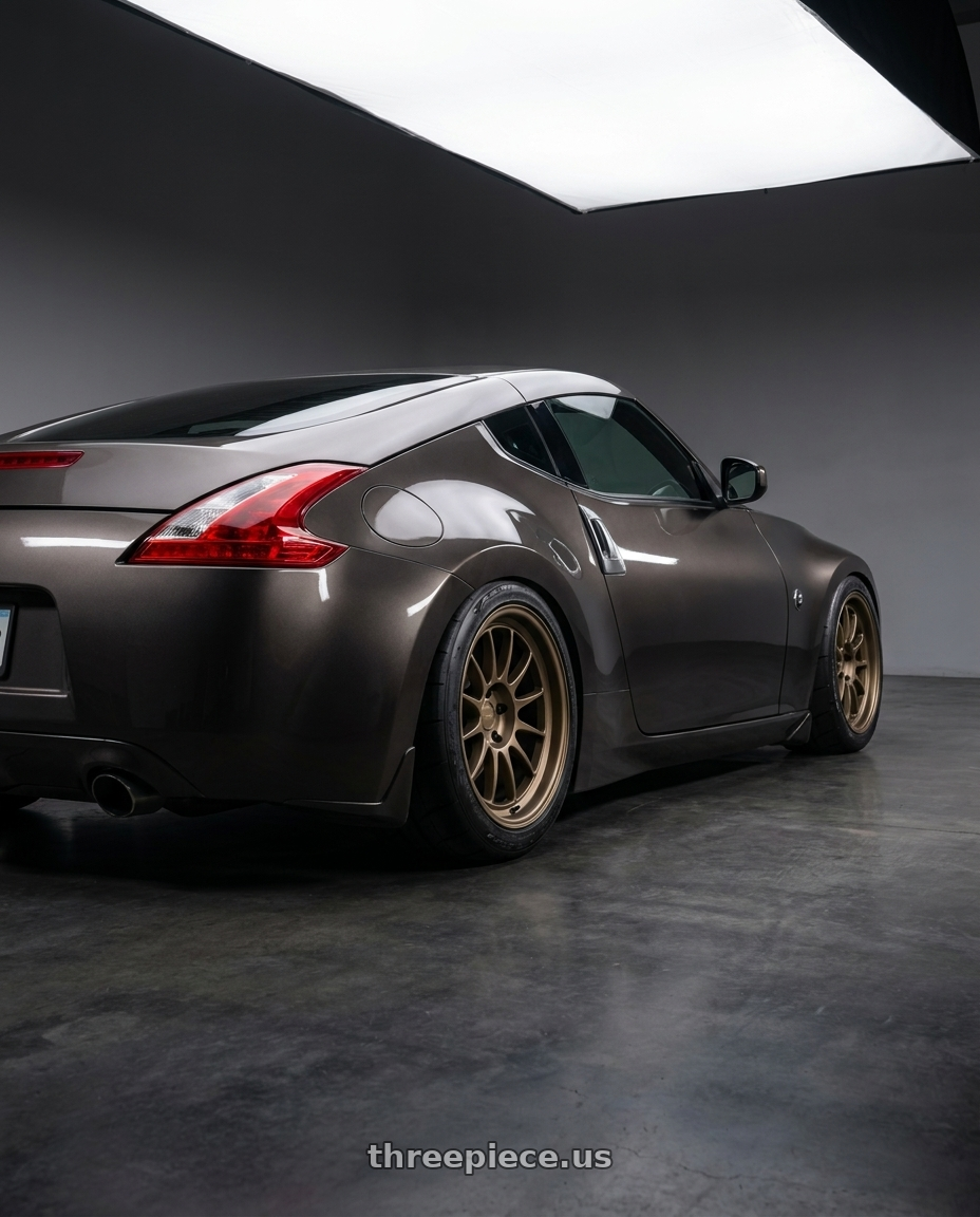 2009 Nissan 370z Magnetic Back Metallic with Kansei K13B Corsa 5x114.3 18x10.5 12 Bronze wheels rear three quarter view meaty tires
