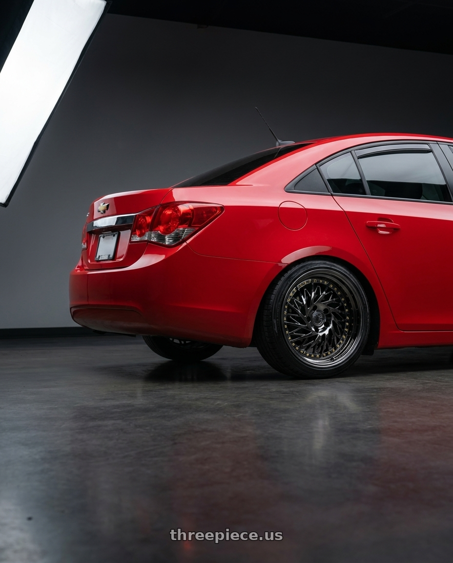 2015 Chevy cruze with Aodhan DS03 5x100 18x9.5 +35 Black Vacuum w/ Gold Rivets wheels rear three quarter view square tires
