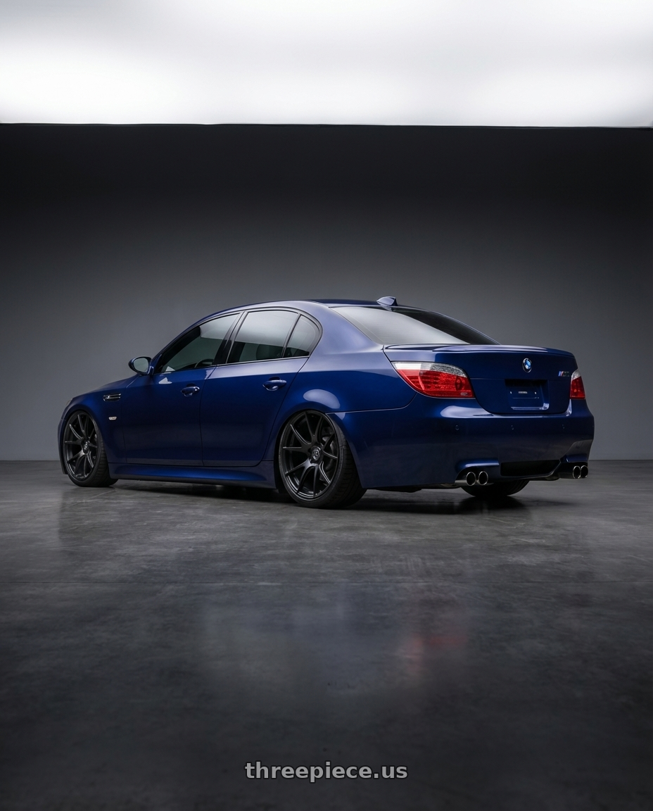 2010 BMW M5 E60 with Forgestar CF5V 5x120 20x12 +52 Satin Black wheels rear three quarter view slight stretch tires