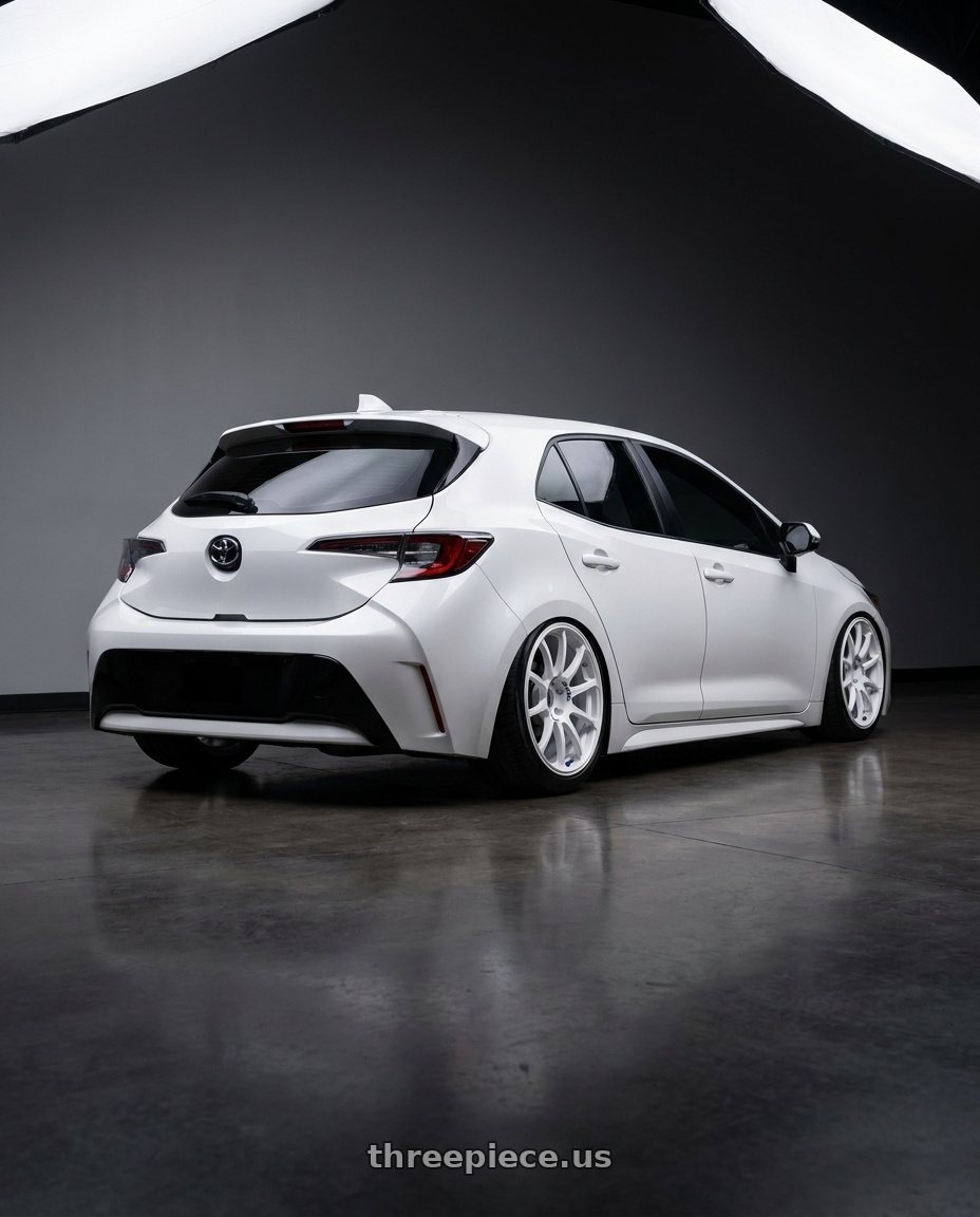 2023 Toyota Corolla Hatchback with Advan RCIII 5x114.3 18x8.5+38 White wheels rear three quarter view slight stretch tires
