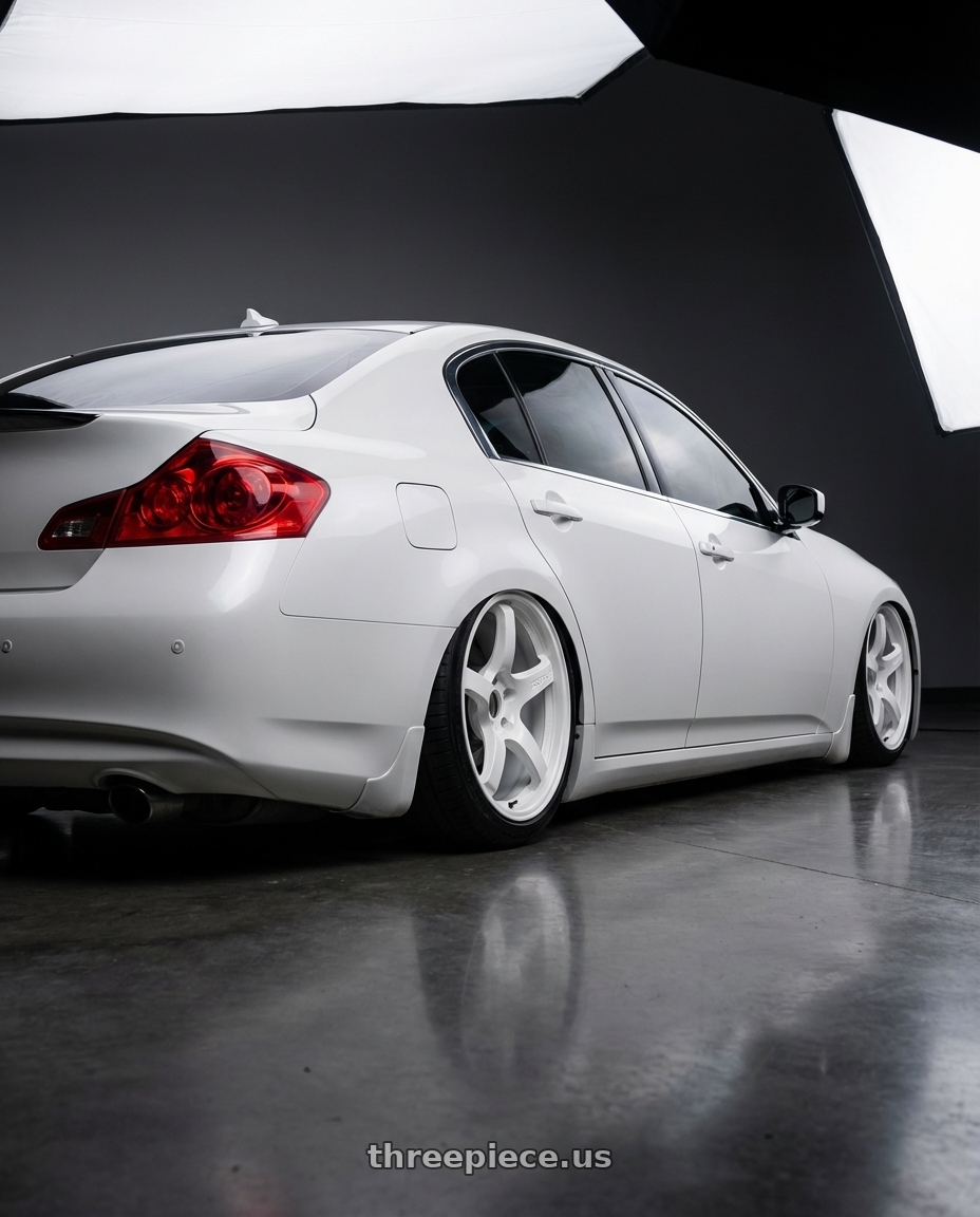2012 Infiniti G37 with Gram Lights 57CR 5x114.3 19x9.5+45 Ceramic Pearl wheels rear three quarter view slight stretch tires