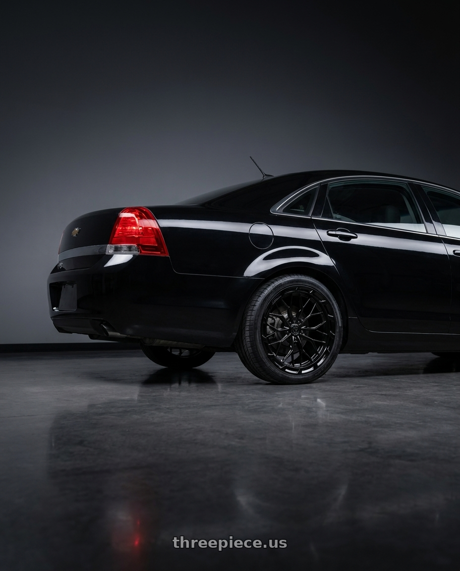 2014 Chevrolet Caprice PPV with DOLCE PERFORMANCE MAGARI 5x120 19x8.5 +28 Gloss Black wheels rear three quarter view square tires