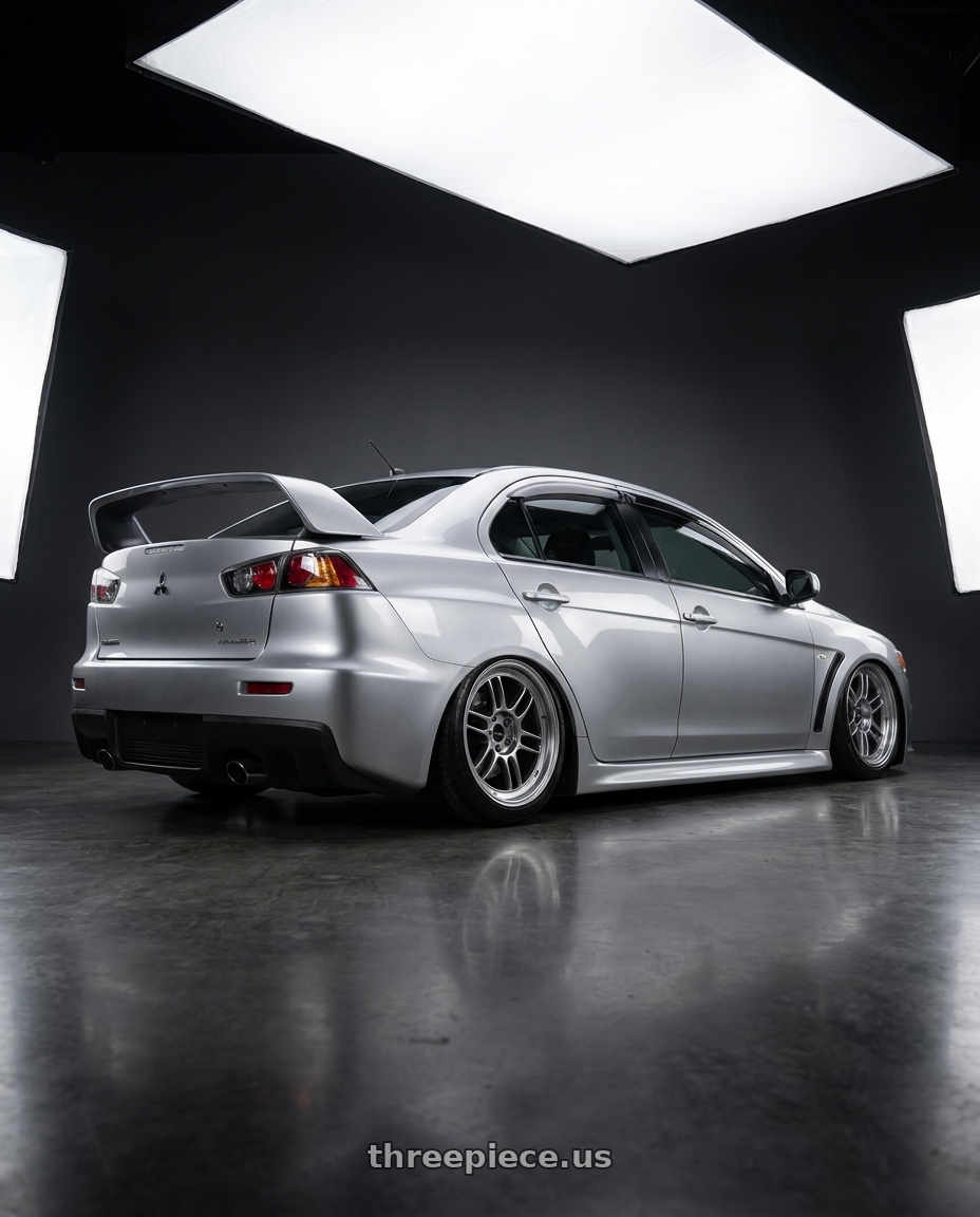 2010 Mitsubishi Lancer Evolution GSR with Enkei RPF1 5x114.3 18x9.5+38 SBC wheels rear three quarter view slight stretch tires