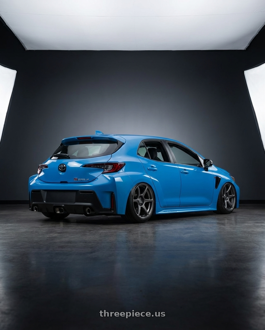 2024 Toyota GR Corolla with Kansei K11G Tandem 5x114.3 18x10.5 12 Gunmetal wheels rear three quarter view slight stretch tires