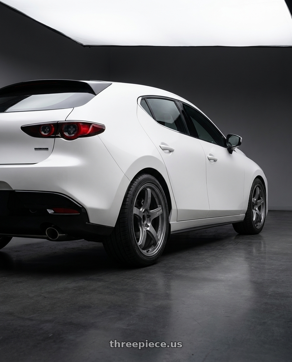 2024 Mazda3 5D with Gram Lights 57CR 5x114.3 18x9.5+38 Glossy Grey wheels rear three quarter view square tires