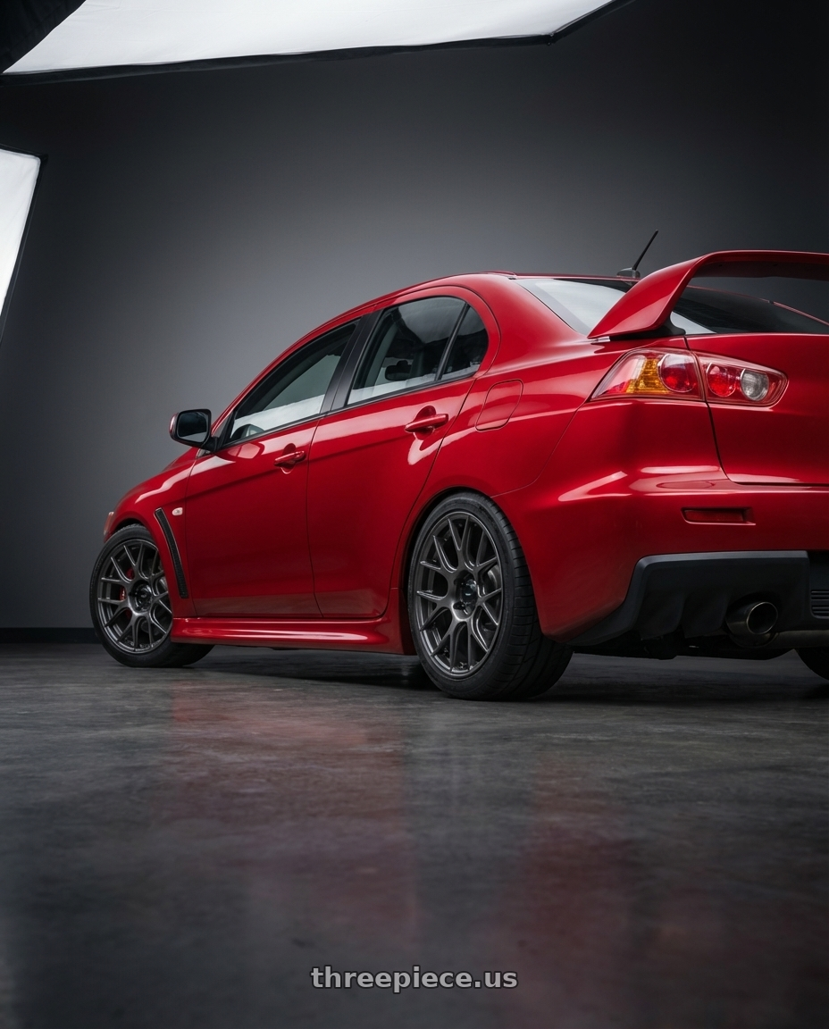 2012 Mitsubishi Lancer Evo X with Konig Ampliform 5x114.3 18x9.5+35 Dark Metallic Graphite wheels rear three quarter view square tires