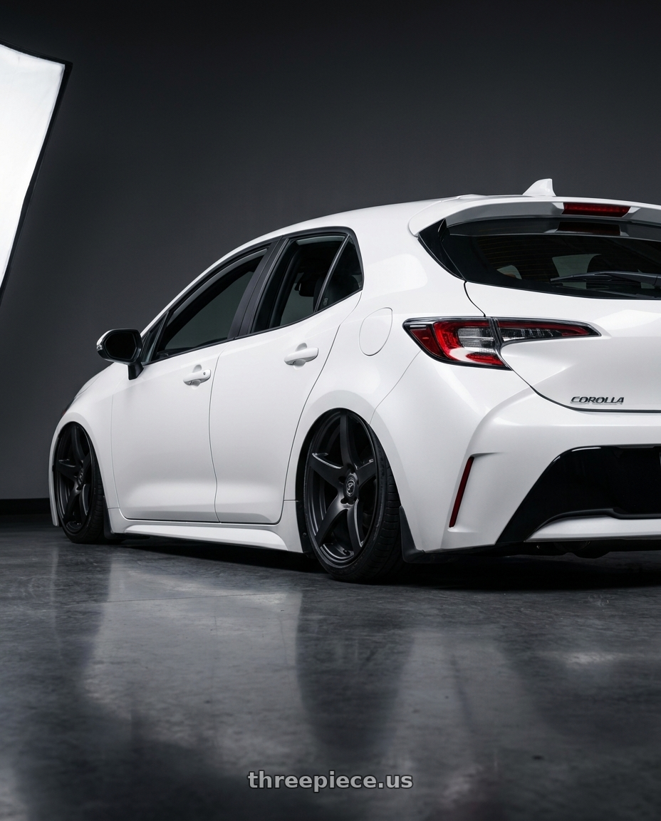 2023 Toyota Corolla Hatchback with Forgestar CF5 5x114.3 18x10 +42 Satin Black wheels rear three quarter view slight stretch tires