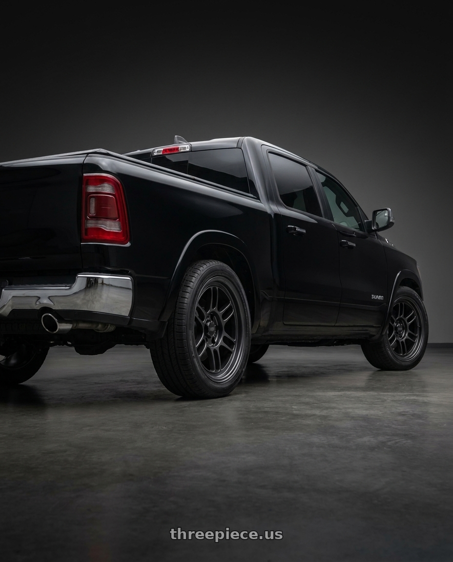 2026 Ram 1500 with Enkei RPT1 6x139.7 18x9+0 Black wheels rear three quarter view square tires
