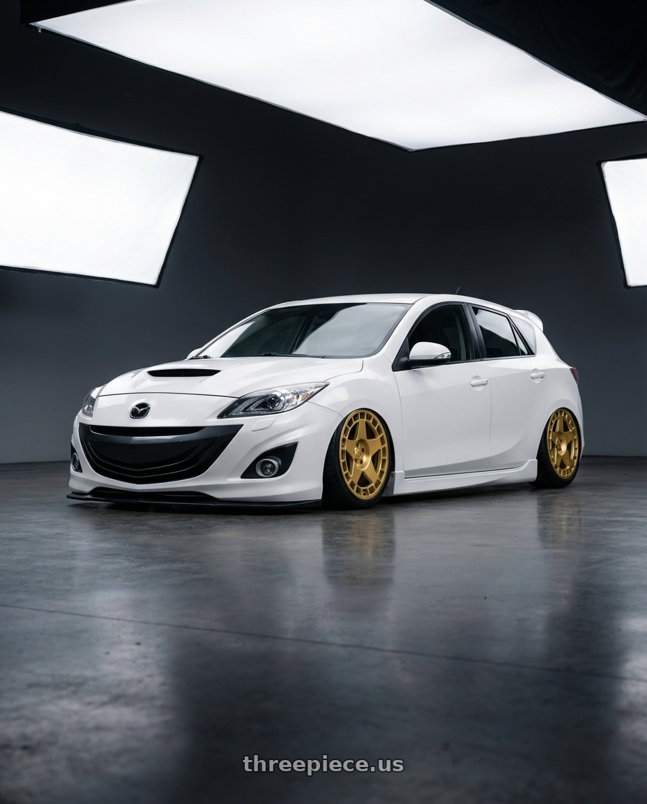 2012 Mazda Mazdaspeed3 with fifteen52 TURBOMAC 5x114.3 18x8.5 +30 GOLD (GLOSS GOLD) wheels front three quarter view stanced stance