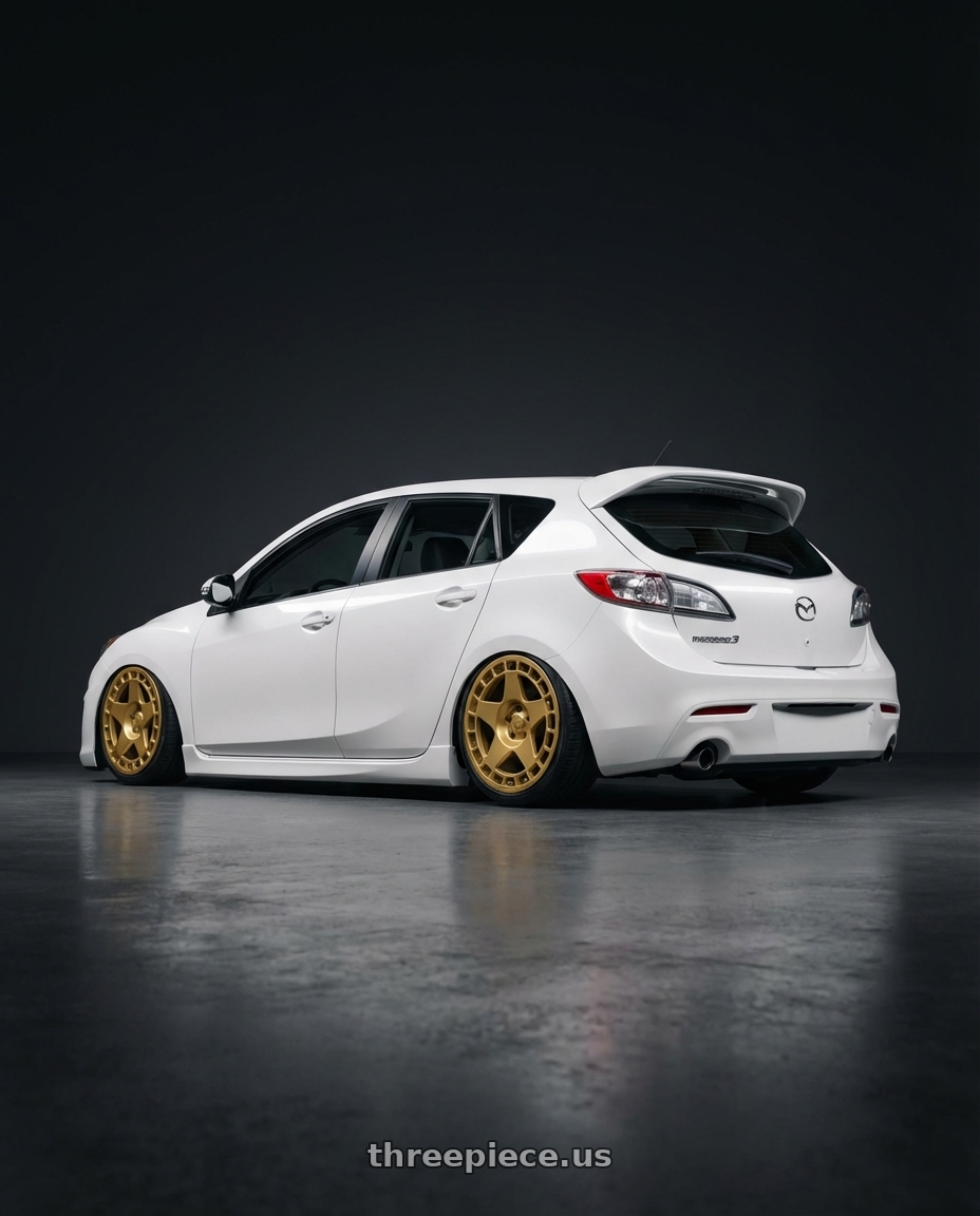 2012 Mazda Mazdaspeed3 with fifteen52 TURBOMAC 5x114.3 18x8.5 +30 GOLD (GLOSS GOLD) wheels rear three quarter view slight stretch tires