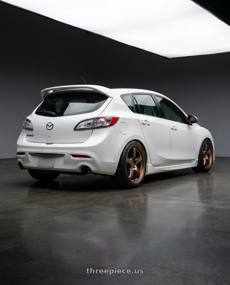 2012 Mazda Mazdaspeed3 with Gram Lights 57CR 5x114.3 18x9.5+12 Bronze II wheels rear three quarter view square tires