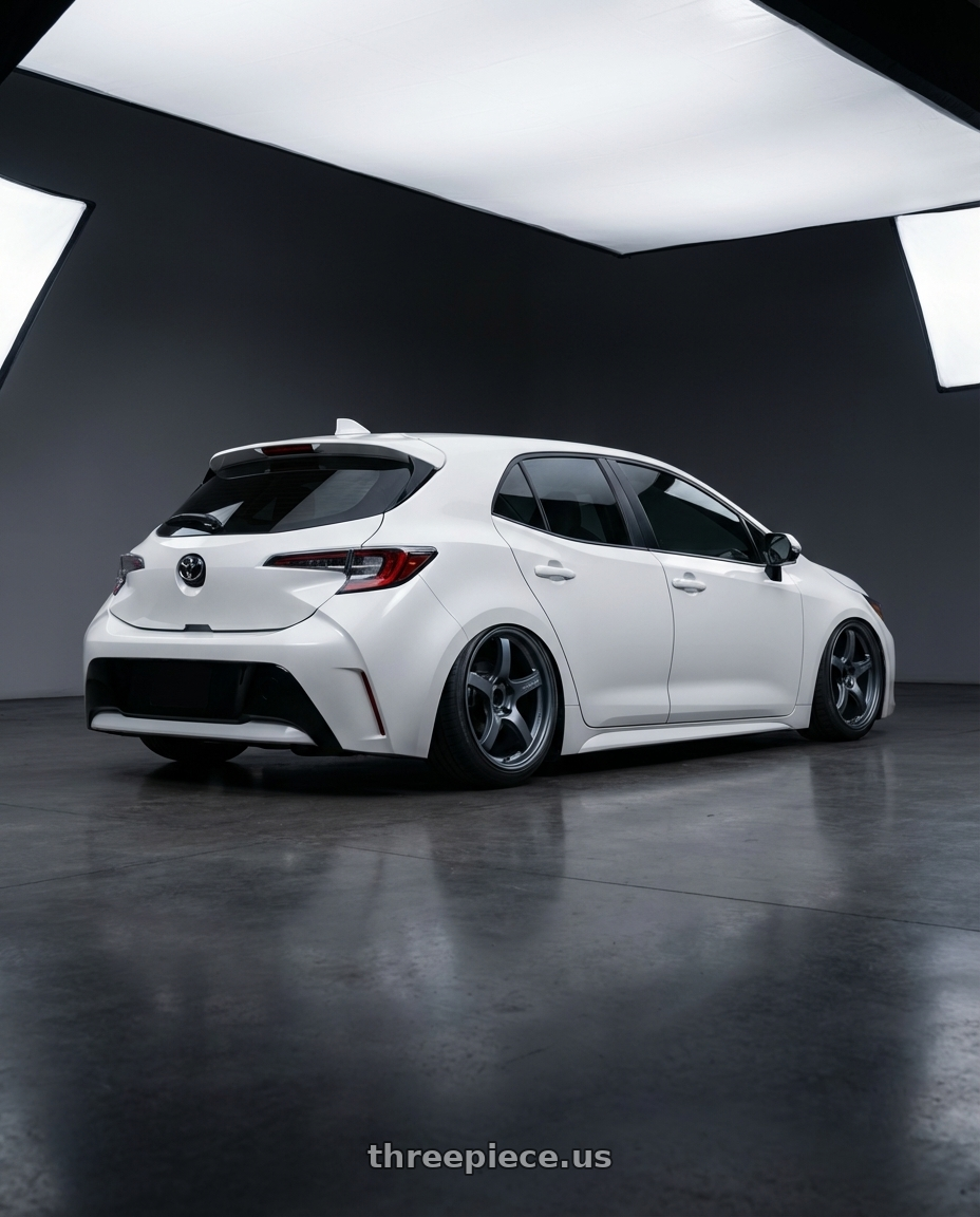 2023 Toyota Corolla Hatchback with Gram Lights 57CR 5x114.3 18x9.5+38 Gunblue II wheels rear three quarter view slight stretch tires