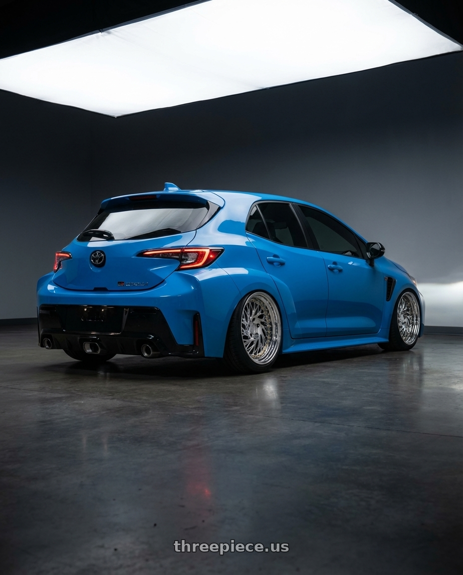 2024 Toyota GR Corolla with Aodhan DS03 5x114.3 18x9.5 +30 Vacuum Chrome w/Gold Rivets wheels rear three quarter view slight stretch tires