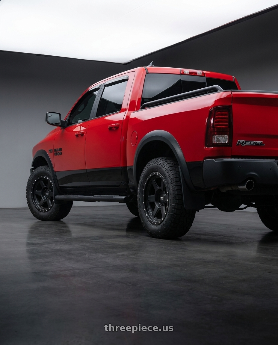 2017 RAM 1500 Rebel with Dirty Life Compound 9315 5x139.7 17x9-12 Matte Black wheels rear three quarter view square tires