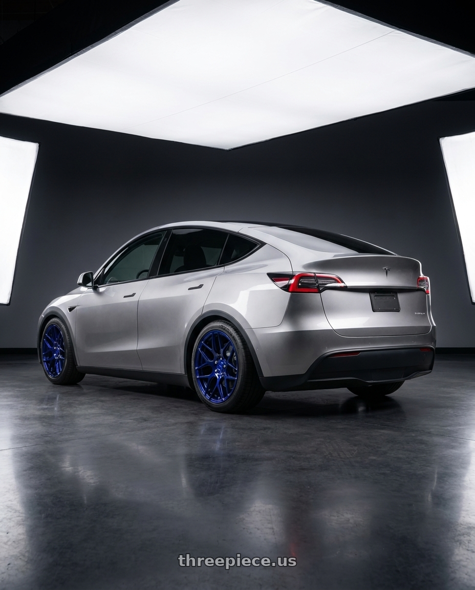 2026 Model Y with MRR FS1 5x130 18x8.5  +45 Candy Blue wheels rear three quarter view square tires