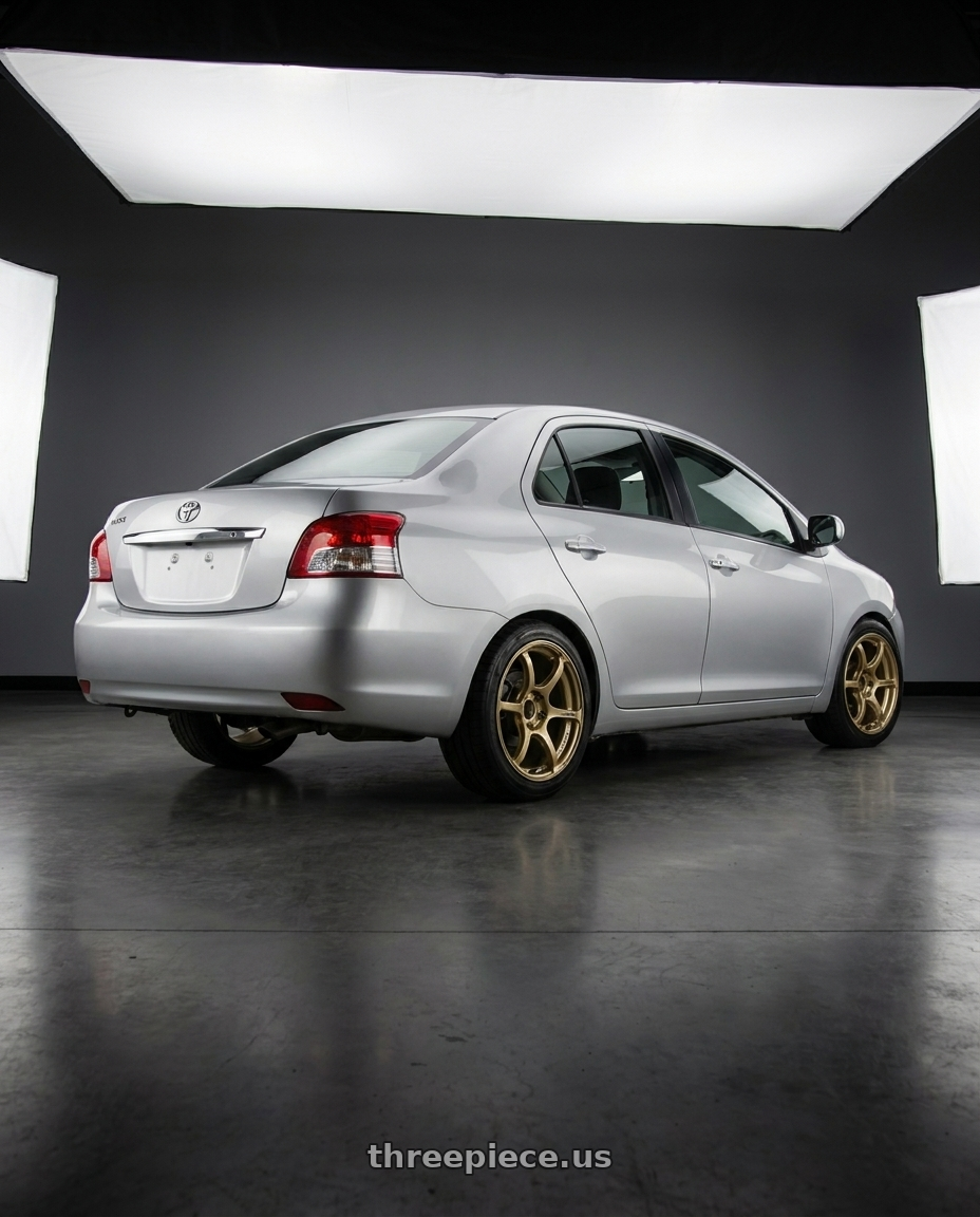 2012 Toyota Vios with Advan RGIII 4x100 18x7.0+42 Gold wheels rear three quarter view square tires