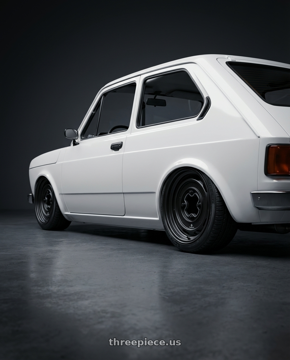 1979 fiat 147 with Mobelwagen MW430B Interceptor 4X130 15x5.5 20 Black wheels rear three quarter view square tires