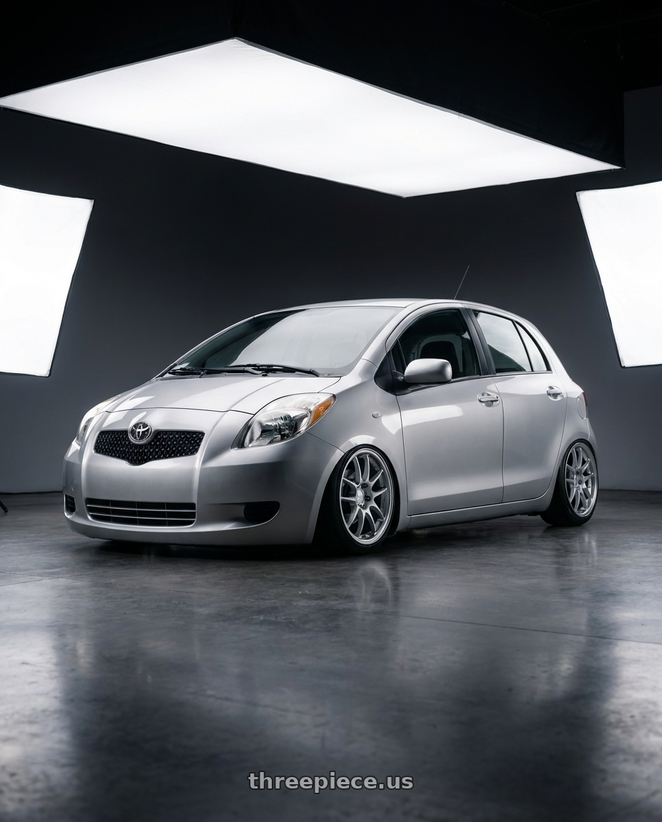 2006 Toyota Yaris with Enkei PF01 4x100 17x7+38 Silver wheels front three quarter view stanced stance