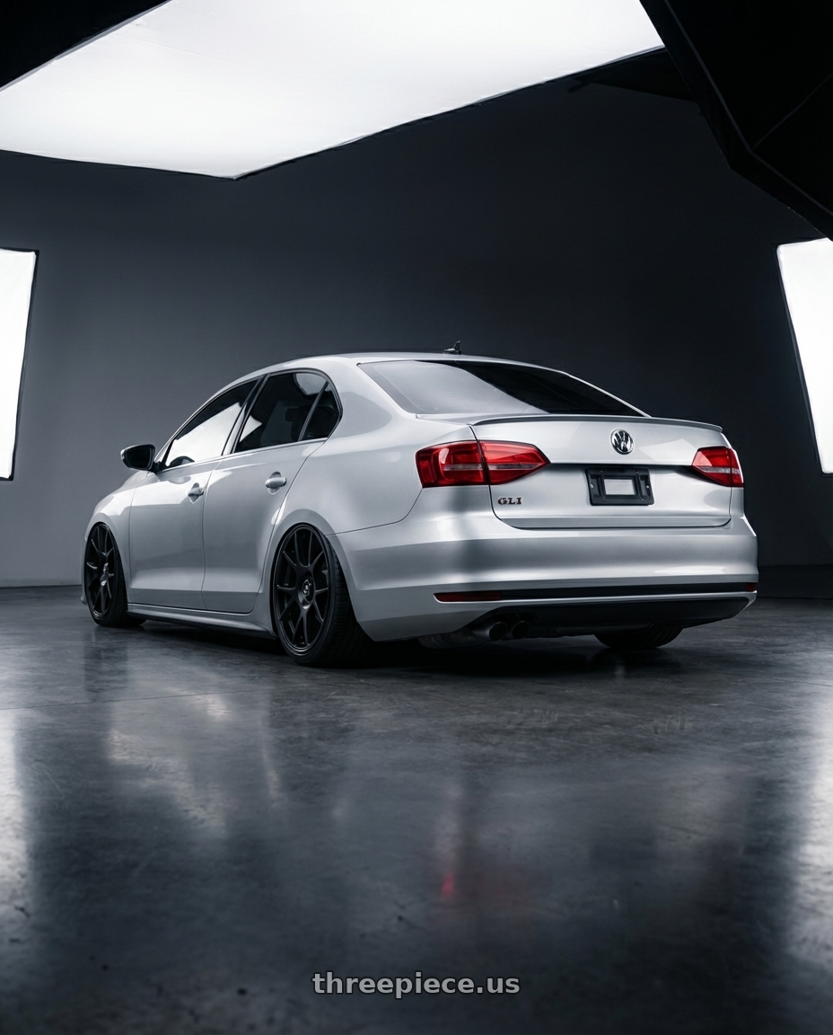 2016 Volkswagen Jetta GLI MK6 with fifteen52 COMP 5x112 / 5x120 18x8.5 +35 ASPHALT BLACK (SATIN BLACK) wheels rear three quarter view slight stretch tires