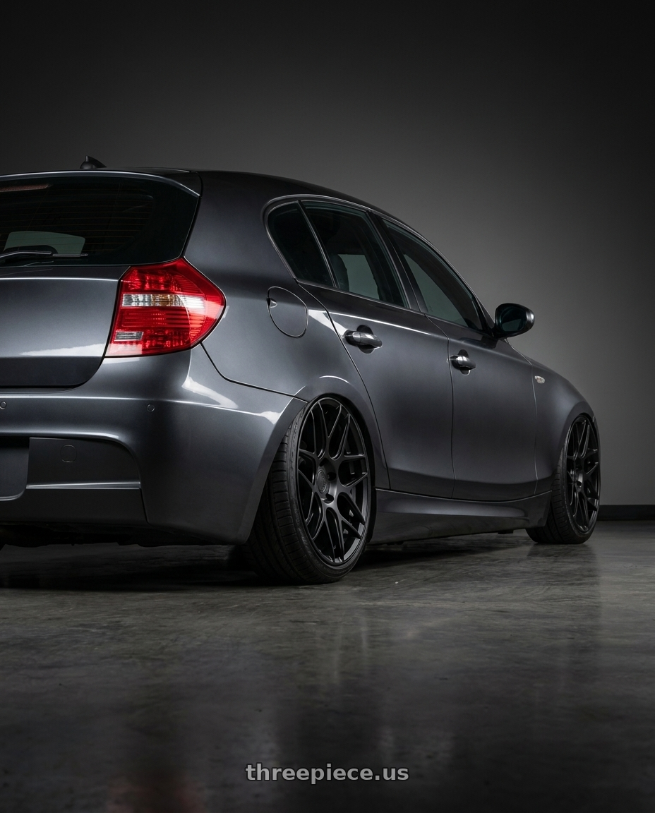 2012 BMW 1 Series E82 with Aodhan AFF2 5x120 19x8.5+35 Matte Black wheels rear three quarter view slight stretch tires