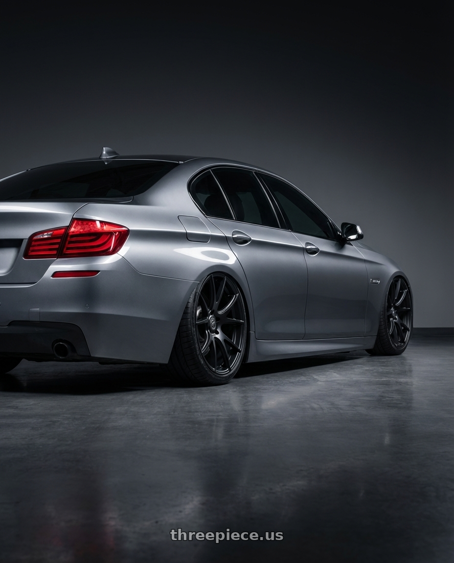 2016 BMW 5 Series F10 with Forgestar CF5V 5x120 20x9 +38 Satin Black wheels rear three quarter view slight stretch tires