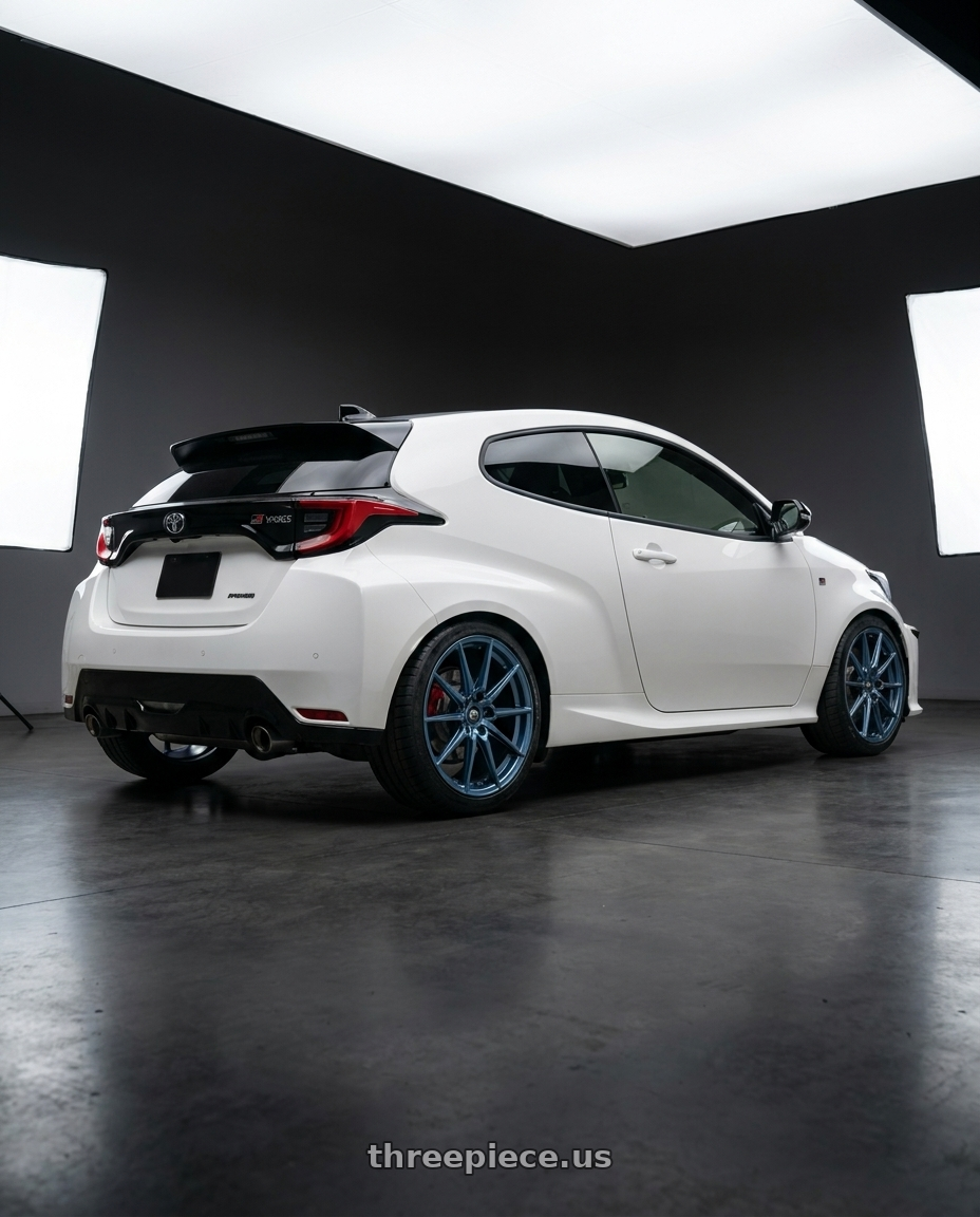 2025 Gr Yaris with MST Wheels DELTA 5X112 18X8.5 +43 Cerulean Blue Pearl wheels rear three quarter view square tires