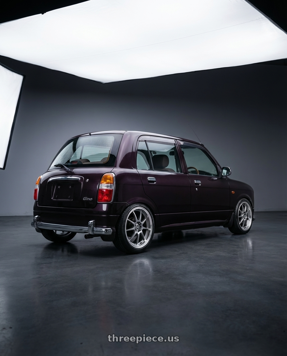 2000 Daihatsu Mira Gino with Enkei J10 4x100/114.3 15x6.5+38 Silver w/ Machined Lip Dia wheels rear three quarter view slight stretch tires