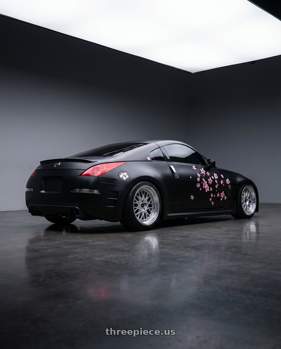 2003 Nissan 350z touring black with ARC AR1 5x114.3 18x9.5  +35 Silver Machine Face Lip Chrome Rivet wheels rear three quarter view square tires