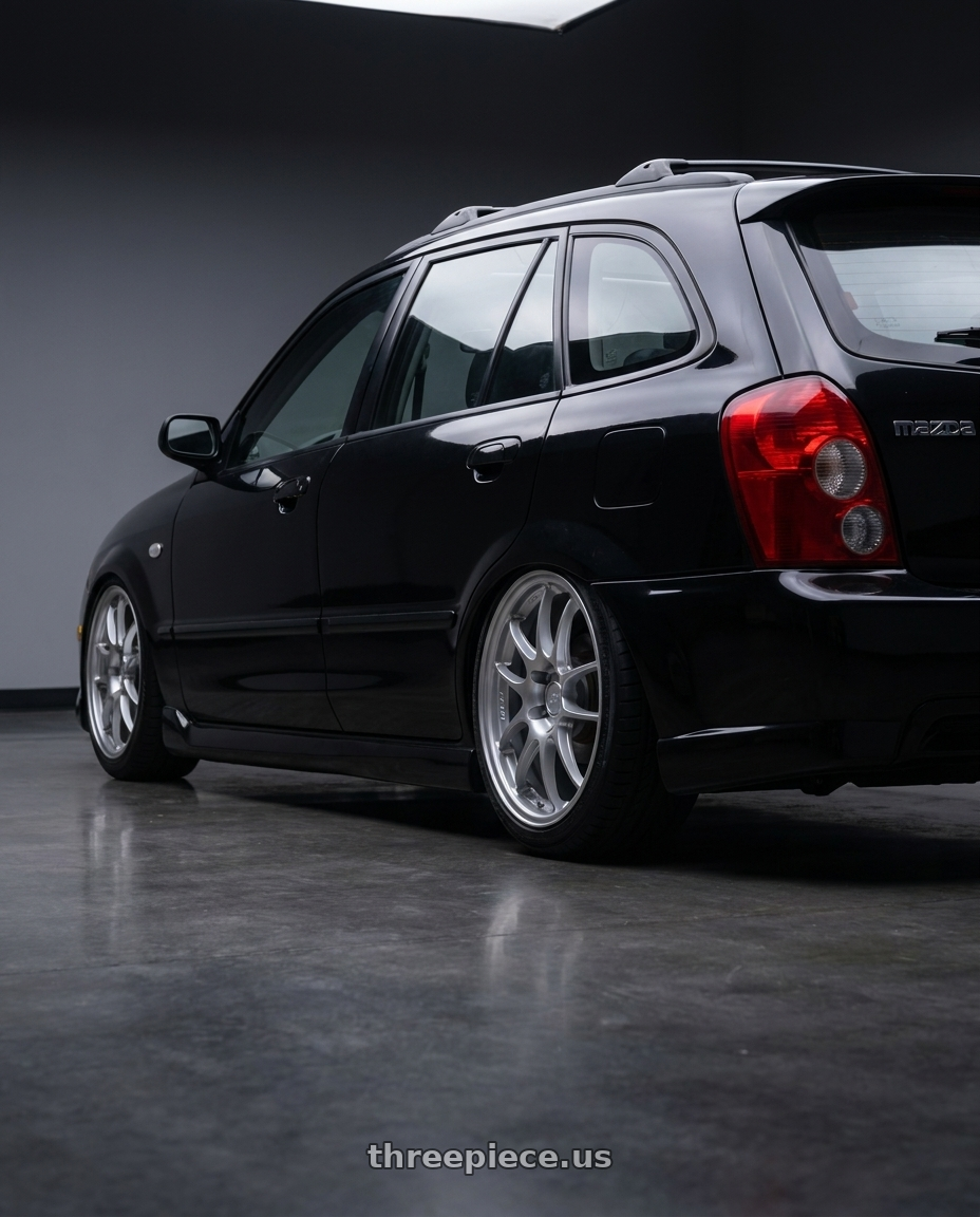 2002 Mazda Protege5 with Enkei PF01 5x114.3 17x7.5+38 Silver wheels rear three quarter view square tires