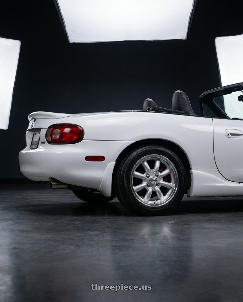 2003 Mazda Miata  with Konig Rewind 4x100 15x7+20 Silver wheels rear three quarter view square tires