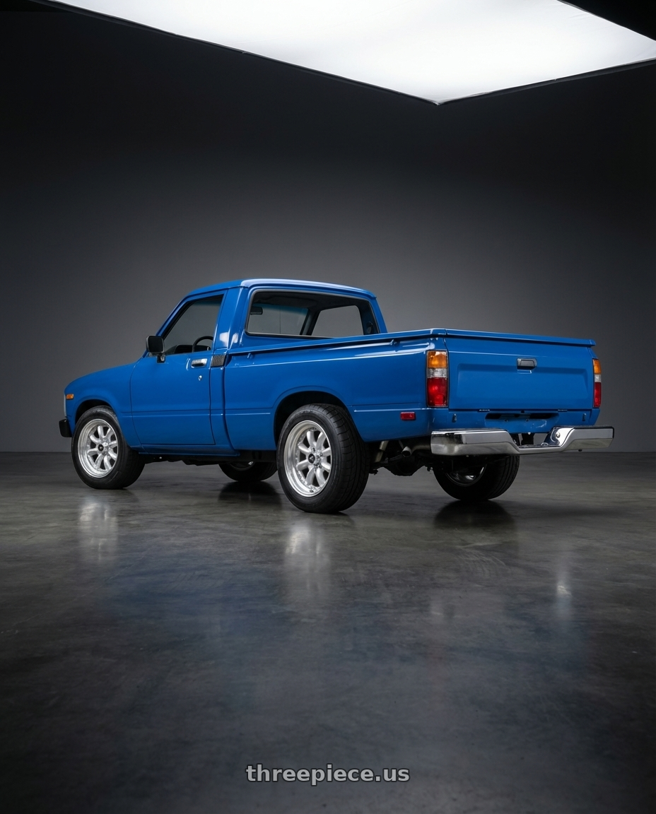 1984 Toyota pickup  with Enkei Compe 4x100 16x7+38 Silver wheels rear three quarter view square tires