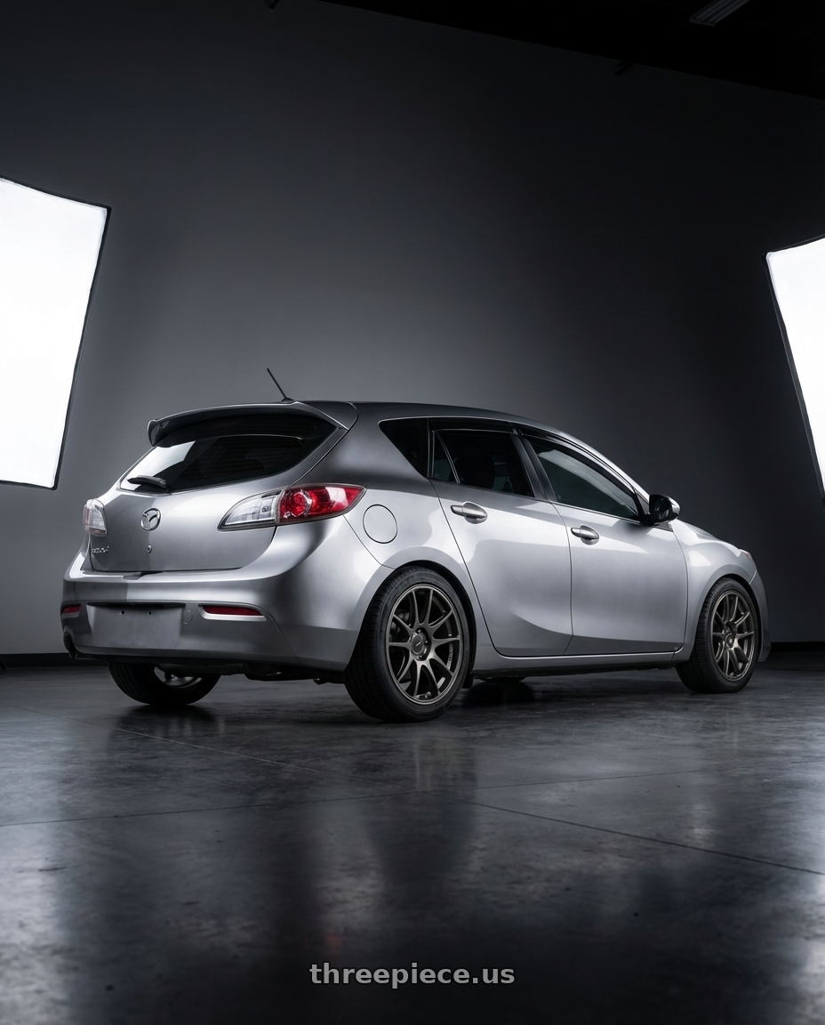 2013 mazda 3 skyactiv silver with Enkei GTC01RR 5x112 18x8.5+45 Matte Gunmetallic wheels rear three quarter view square tires