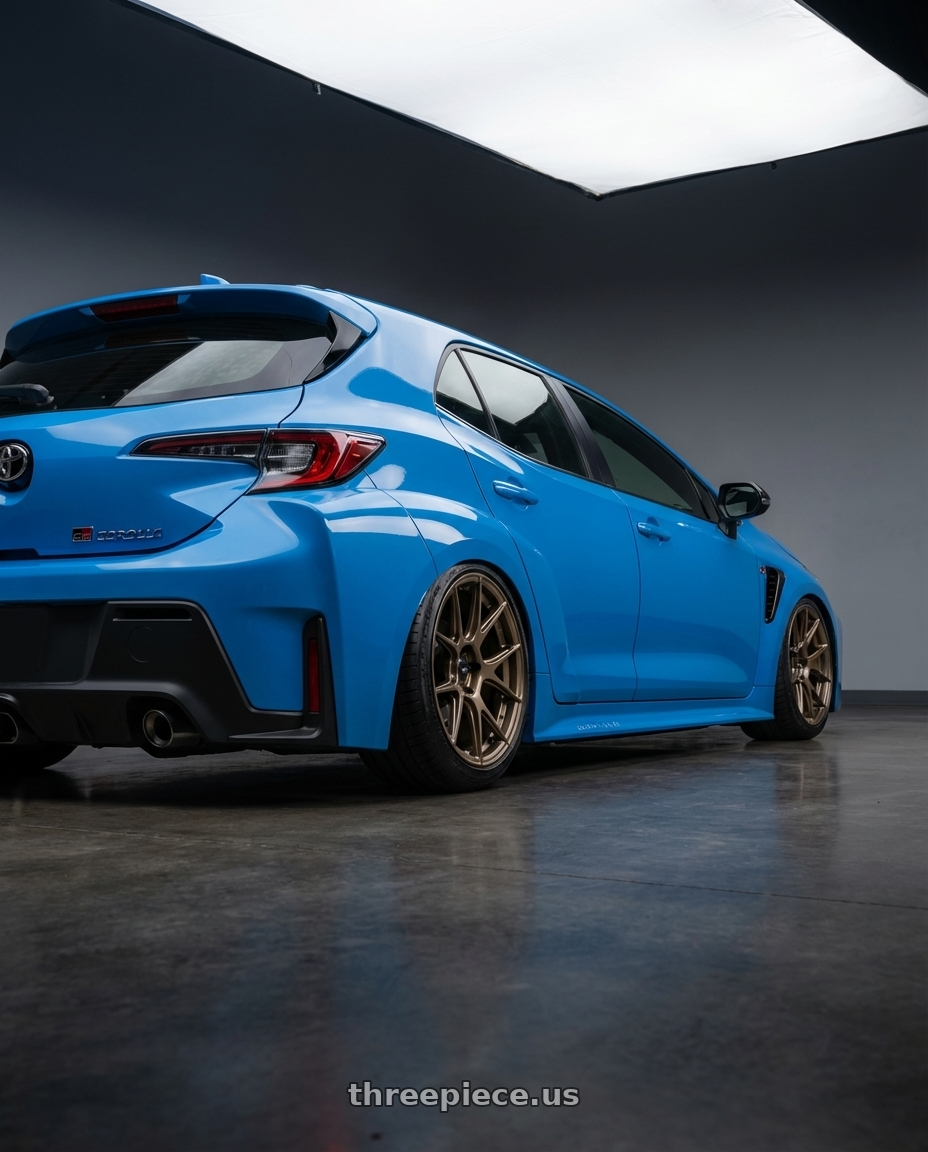 2024 Toyota GR Corolla with Konig Ampliform 5x114.3 18x9.5+25 Gloss Bronze wheels rear three quarter view slight stretch tires
